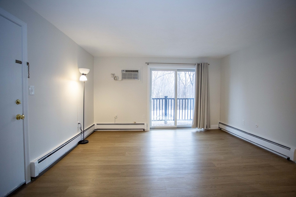 5 Washington Street, Unit C9 Reading, MA 01867 - Photo 2 of 21 an empty room with wooden floor and windows