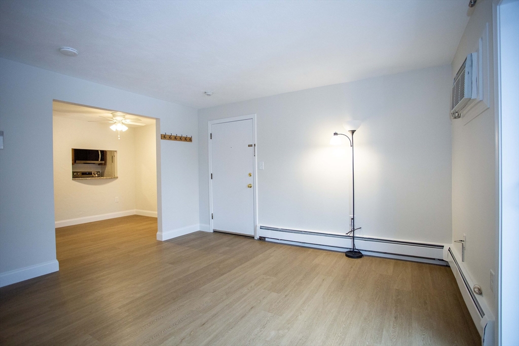 5 Washington Street, Unit C9 Reading, MA 01867 - Photo 5 of 21 an empty room with wooden floor and windows