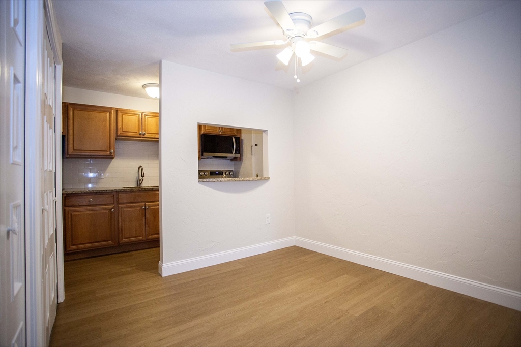 5 Washington Street, Unit C9 Reading, MA 01867 - Photo 6 of 21 a view of a kitchen with a microwave and a stove