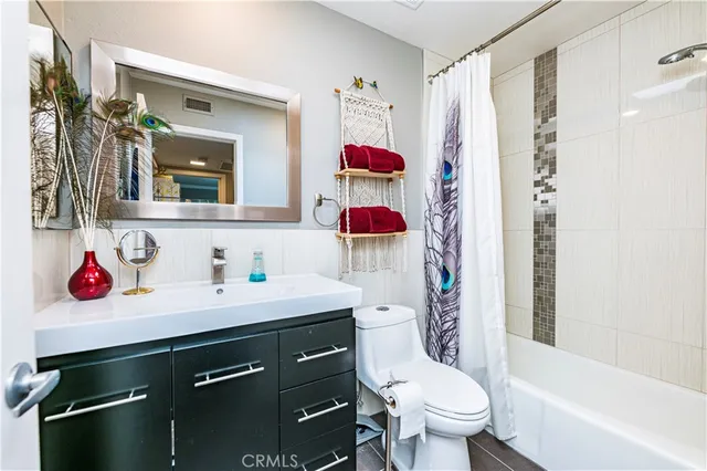 a bathroom with a sink toilet vanity and shower