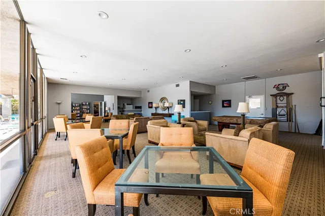 a living room with furniture wooden floor and a large window