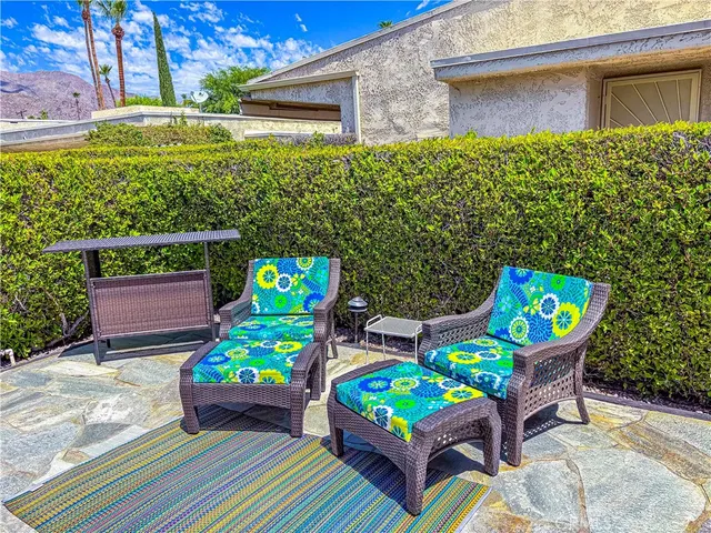 a wooden bench sitting in front of a building