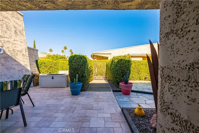 a view of a patio with dining table and chairs