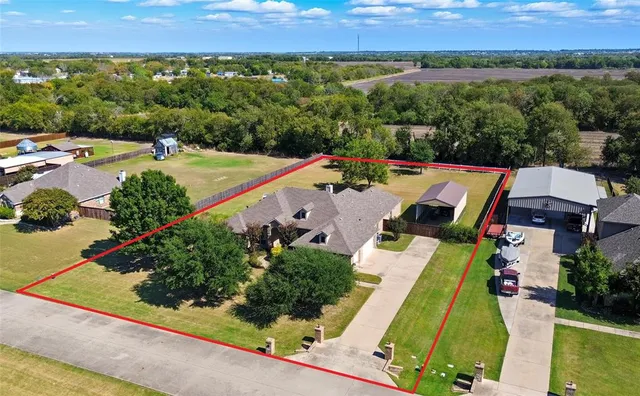 an aerial view of a house with a garden and lake view
