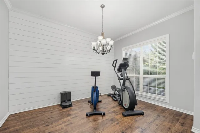 a large kitchen with cabinets table and chairs