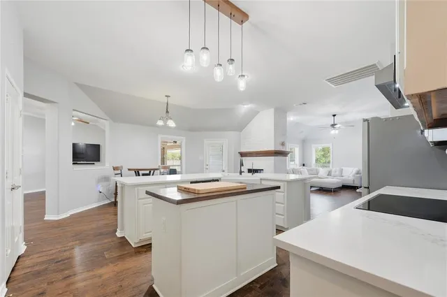 a kitchen with a sink a counter space appliances and cabinets