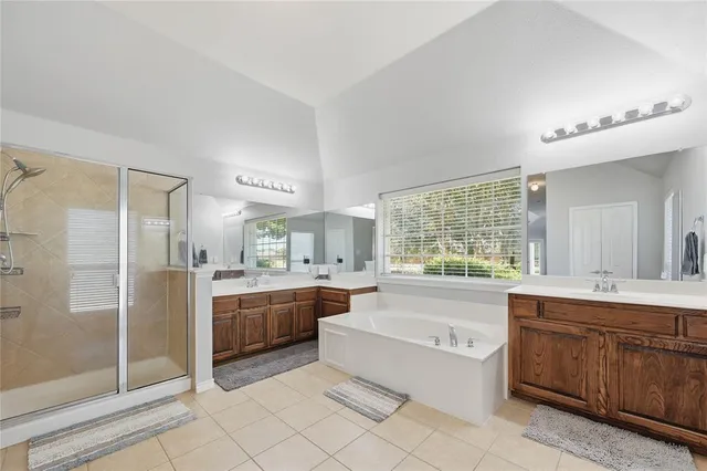 a bedroom with a bed and a ceiling fan