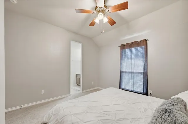 an empty room with closet and windows