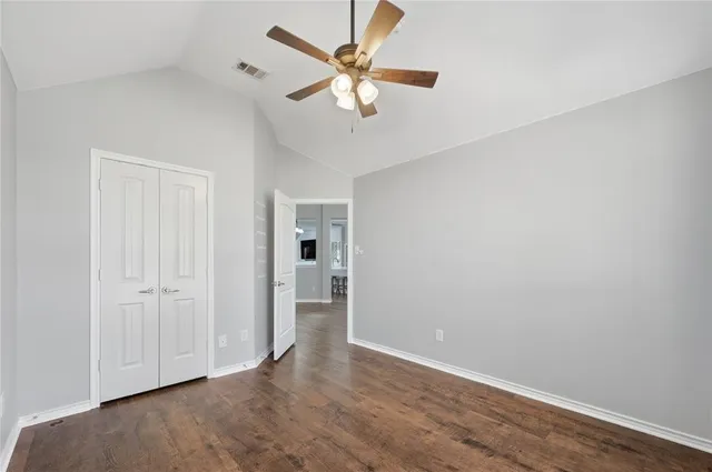 a view of a white house with a large pool and couches chairs