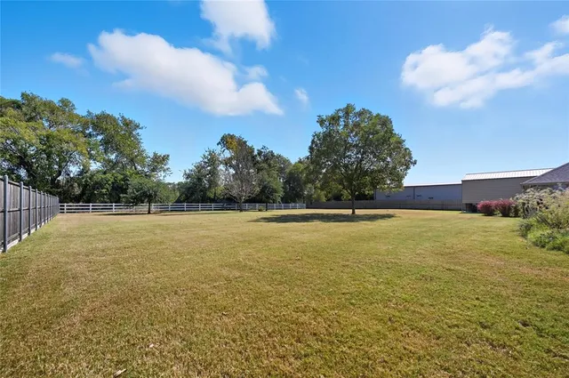 a kitchen with stainless steel appliances kitchen island granite countertop a dining table chairs and sink