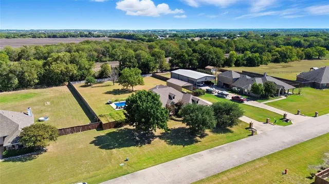 swimming pool view with a garden and plants