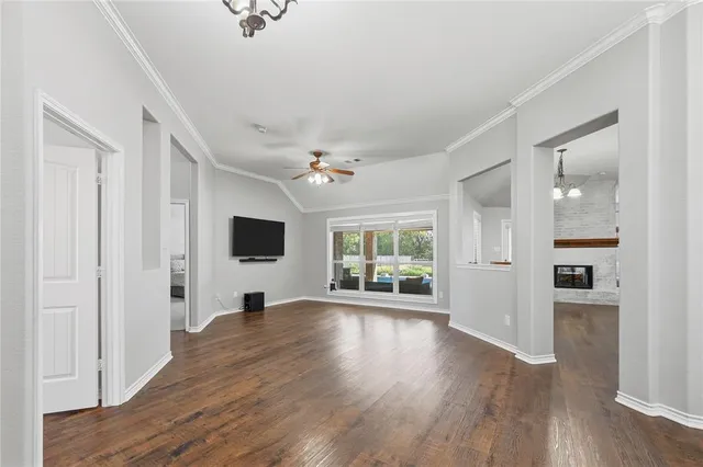 a dining room with furniture potted plants and wooden floor
