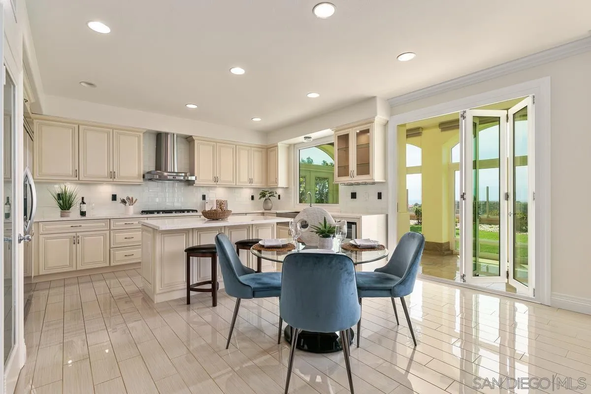 7337 Melodia Terrace Carlsbad, CA 92011 - Photo 12 of 42 a view of kitchen with cabinets table and chairs