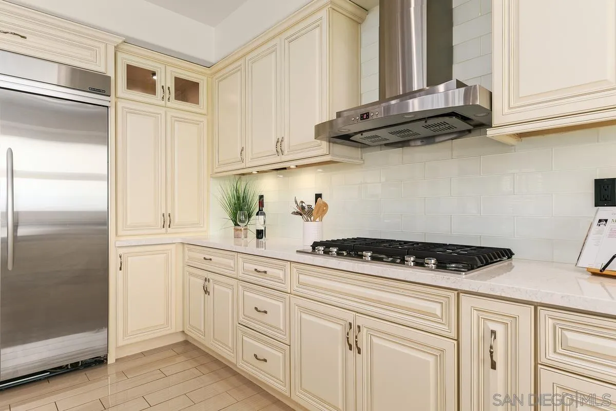 7337 Melodia Terrace Carlsbad, CA 92011 - Photo 14 of 42 a kitchen with stainless steel appliances cabinets and a window