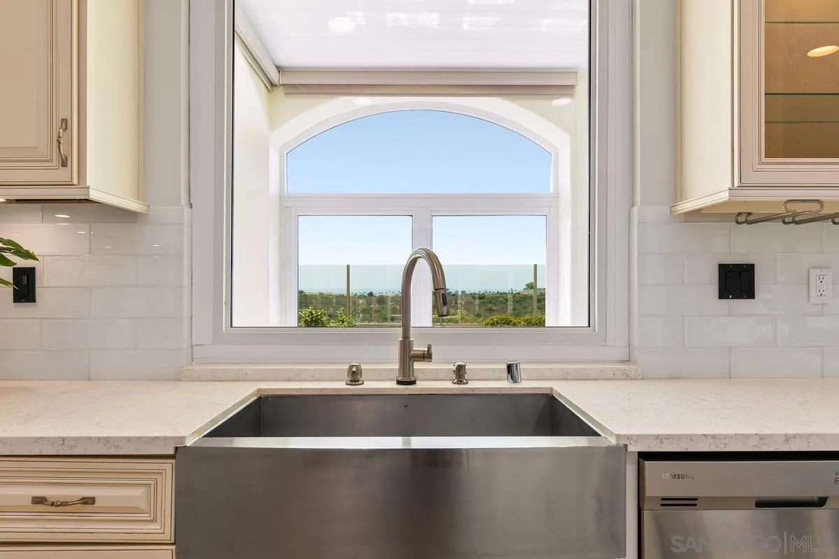 7337 Melodia Terrace Carlsbad, CA 92011 - Photo 15 of 42 a kitchen with a sink and a stove with a sink