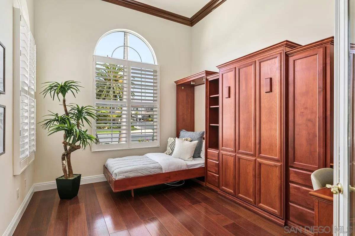 7337 Melodia Terrace Carlsbad, CA 92011 - Photo 18 of 42 a bedroom with furniture and a window