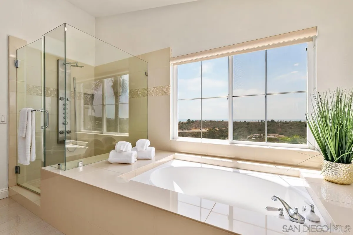 7337 Melodia Terrace Carlsbad, CA 92011 - Photo 27 of 42 a living room with a large window and table
