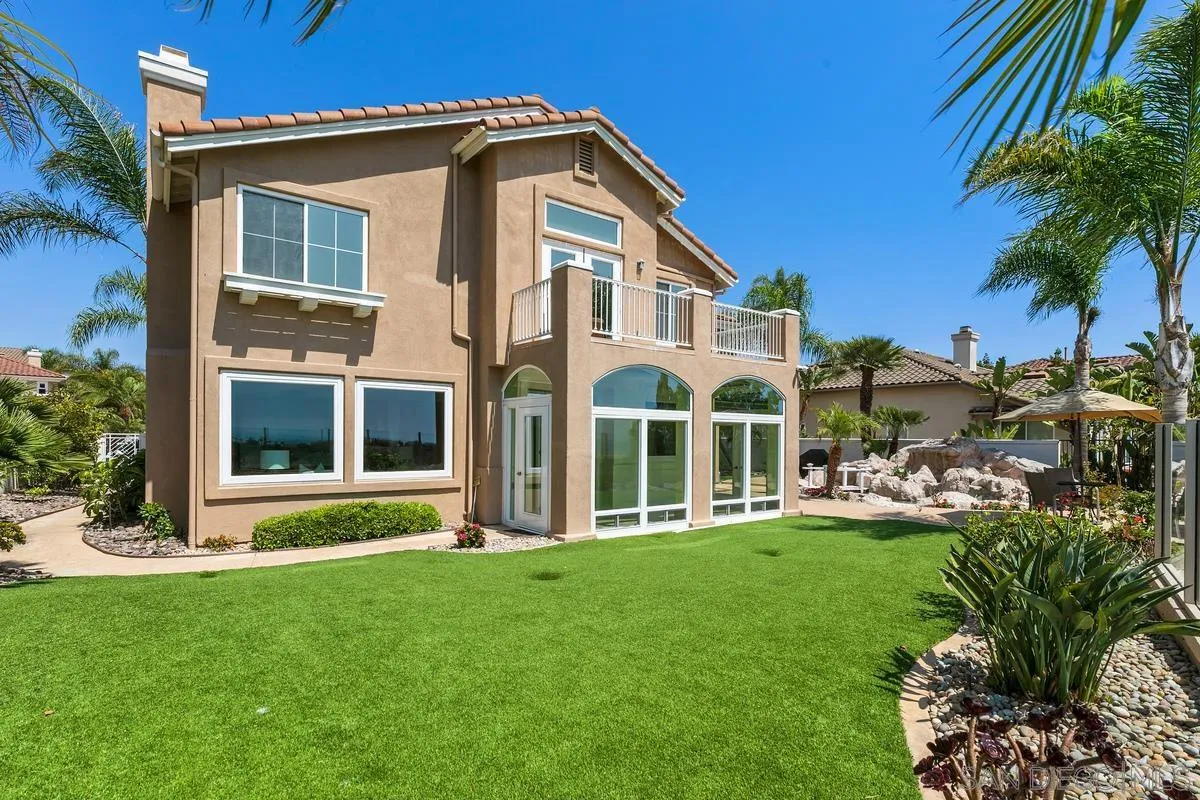 7337 Melodia Terrace Carlsbad, CA 92011 - Photo 37 of 42 a front view of a house with a yard table and chairs
