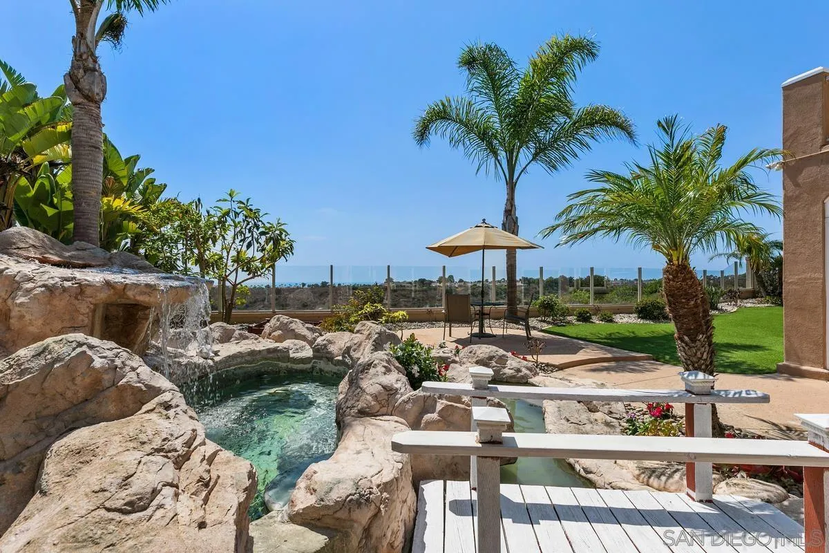 7337 Melodia Terrace Carlsbad, CA 92011 - Photo 39 of 42 a view of swimming pool with table and chairs under an umbrella
