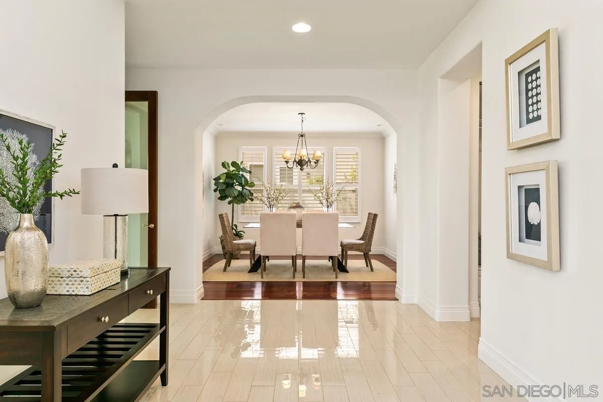 7337 Melodia Terrace Carlsbad, CA 92011 - Photo 7 of 42 a living room with furniture and a chandelier