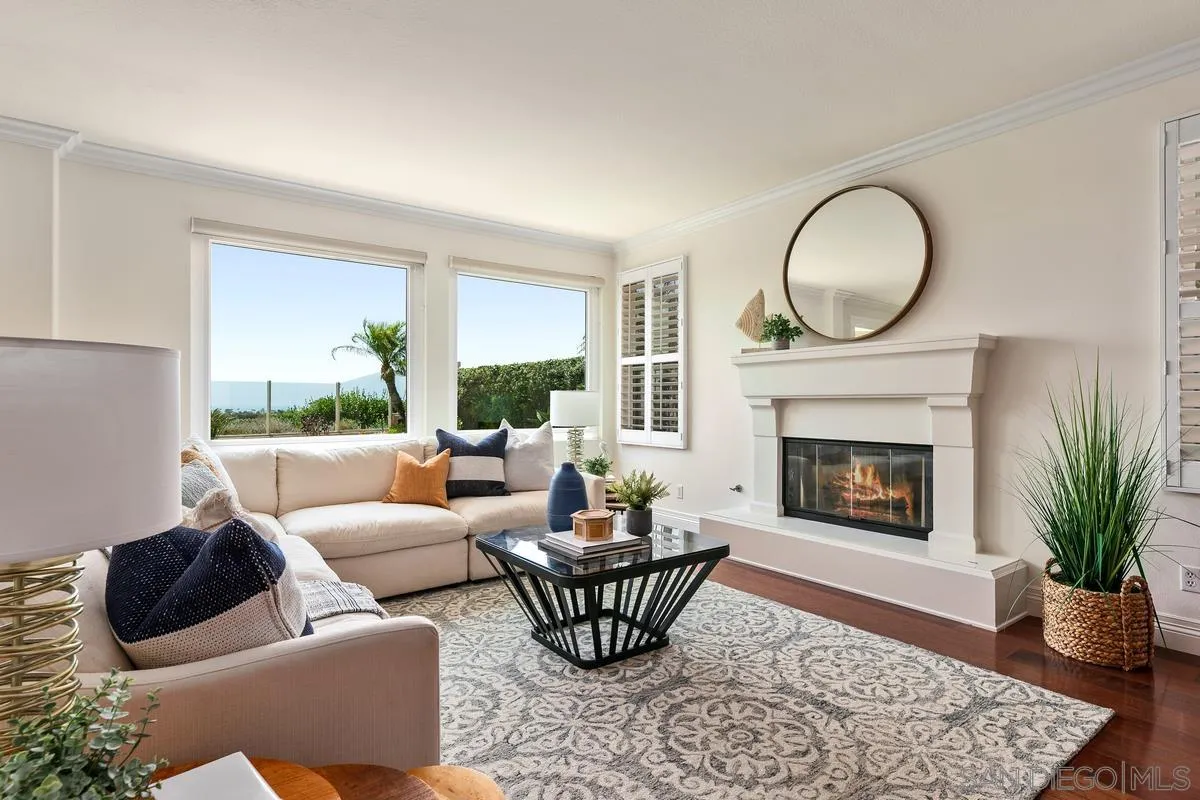 7337 Melodia Terrace Carlsbad, CA 92011 - Photo 10 of 42 a living room with furniture a fireplace a window and a fireplace
