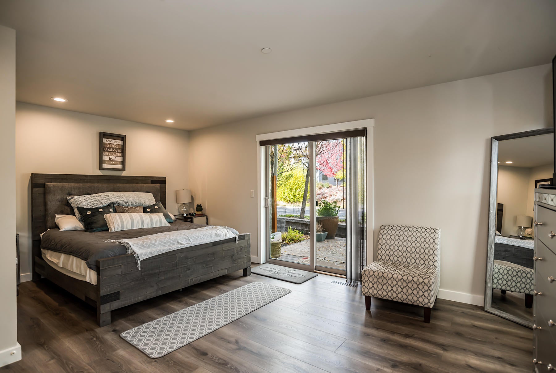600 Southwest Otter Way Bend, OR 97702 - Photo 11 of 38 Main floor bedroom with a closet, windows and slider to a private patio.