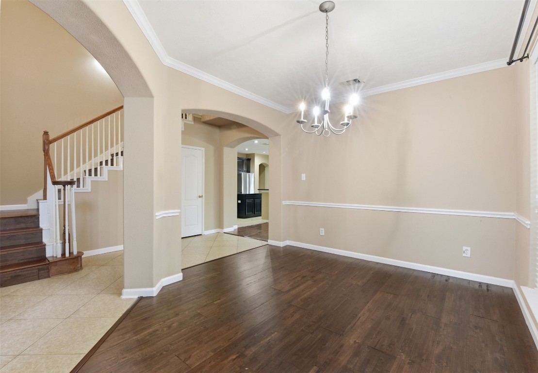 24938 Crystal Stone Lane Katy, TX 77494 - Photo 11 of 50 a view of a livingroom with wooden floor and a chandelier