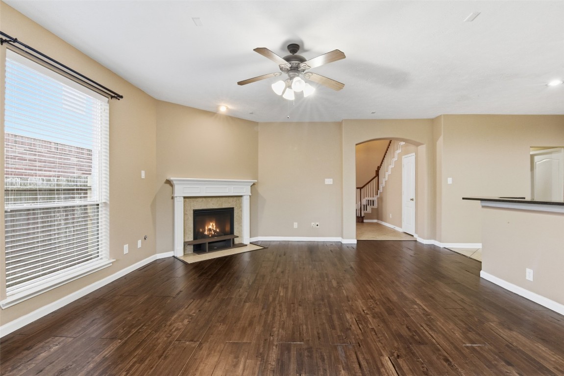 24938 Crystal Stone Lane Katy, TX 77494 - Photo 15 of 50 a view of an empty room with wooden floor fireplace and a window