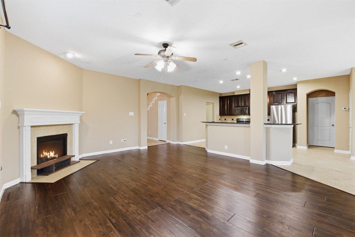24938 Crystal Stone Lane Katy, TX 77494 - Photo 17 of 50 a view of an empty room with kitchen and fire place