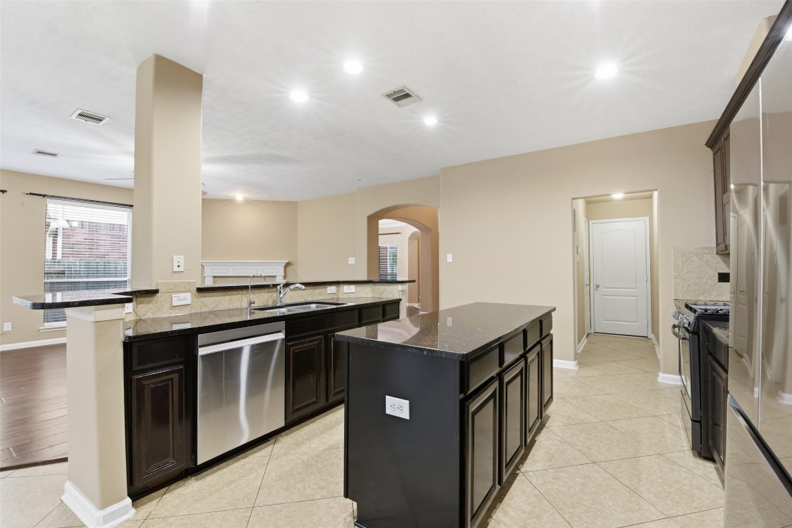 24938 Crystal Stone Lane Katy, TX 77494 - Photo 19 of 50 a kitchen with stainless steel appliances granite countertop a sink and stove