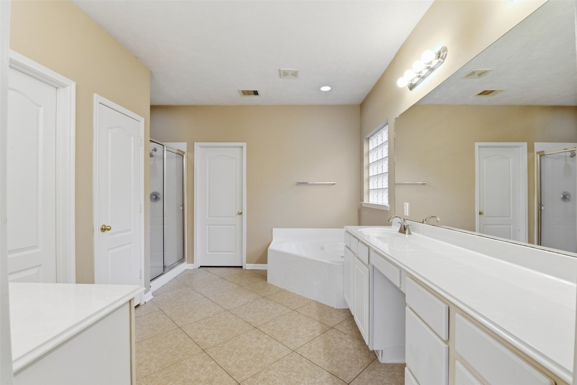 24938 Crystal Stone Lane Katy, TX 77494 - Photo 30 of 50 a spacious bedroom with a bed and a cabinets