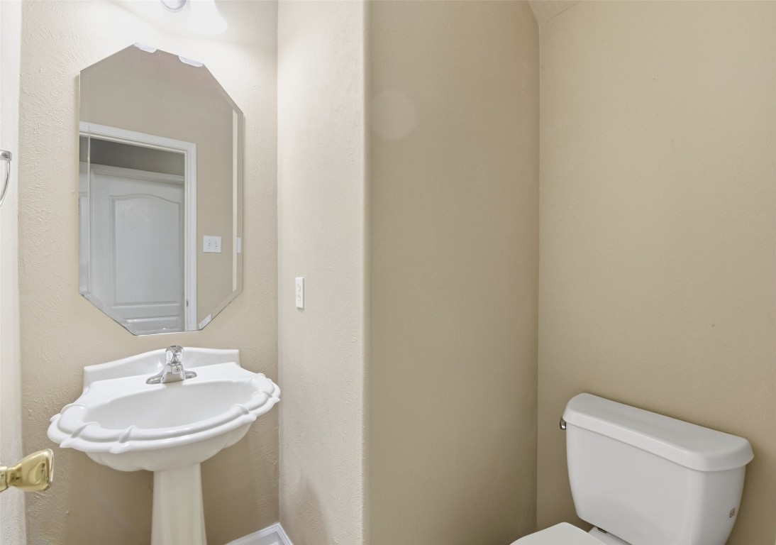 24938 Crystal Stone Lane Katy, TX 77494 - Photo 35 of 50 a bathroom with a toilet sink and mirror