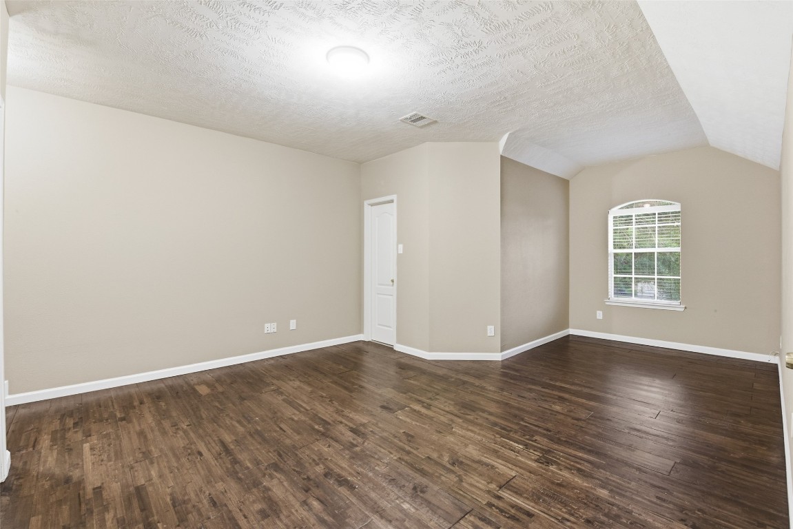 24938 Crystal Stone Lane Katy, TX 77494 - Photo 39 of 50 an empty room with wooden floor and windows