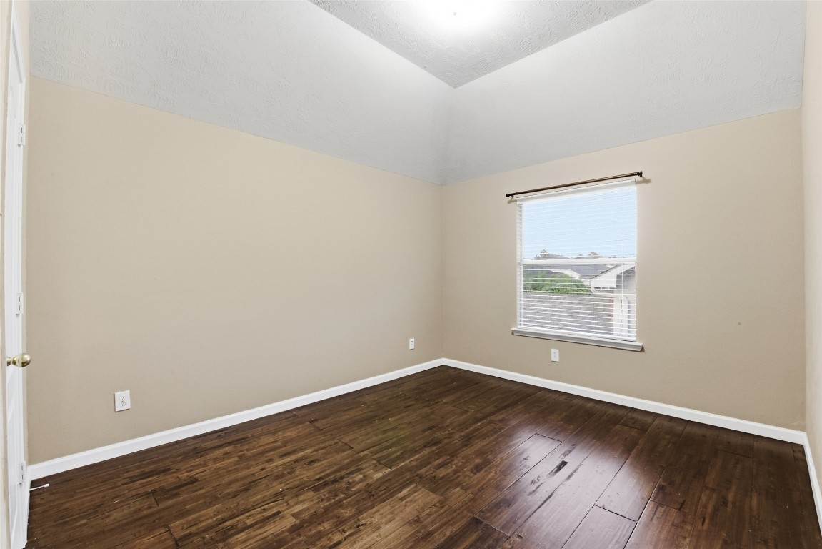 24938 Crystal Stone Lane Katy, TX 77494 - Photo 46 of 50 an empty room with wooden floor and windows