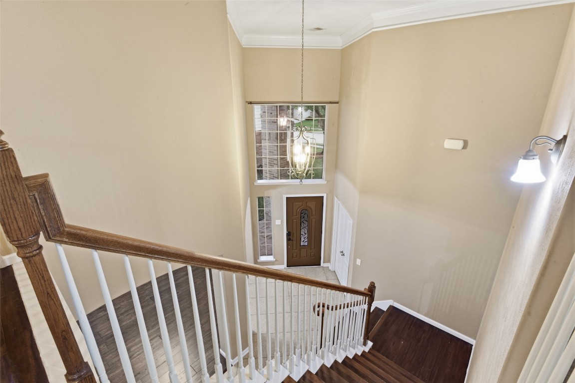 24938 Crystal Stone Lane Katy, TX 77494 - Photo 48 of 50 a view of a hallway with wooden floor and staircase