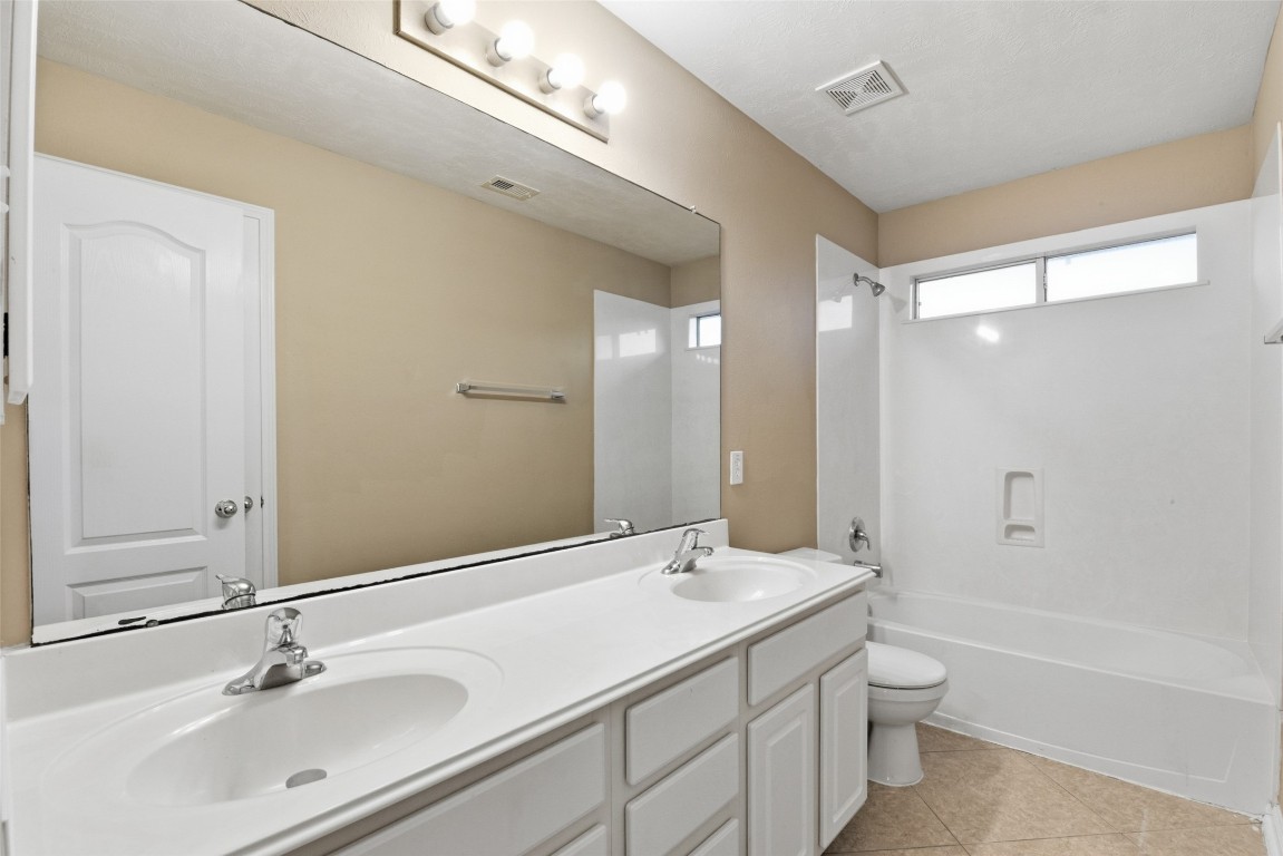 24938 Crystal Stone Lane Katy, TX 77494 - Photo 49 of 50 a bathroom with a double vanity sink mirror double and bathtub