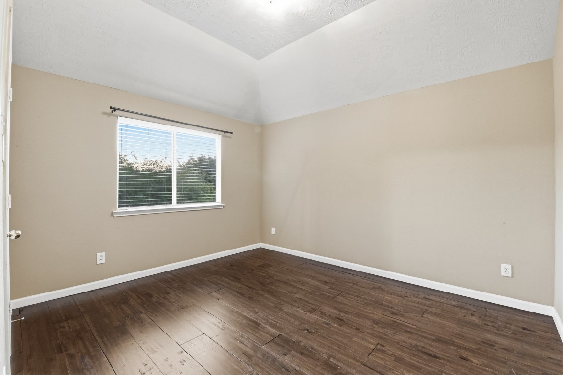 24938 Crystal Stone Lane Katy, TX 77494 - Photo 50 of 50 a view of an empty room with wooden floor and a window