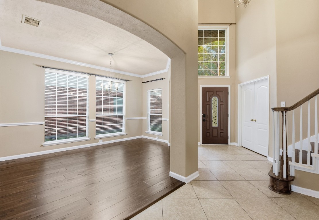 24938 Crystal Stone Lane Katy, TX 77494 - Photo 9 of 50 a view of an empty room with wooden floor and a window