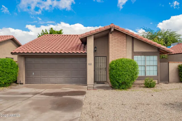 a view of a house with a yard and garage