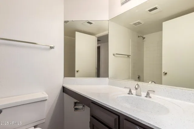 an empty room and chandelier fan