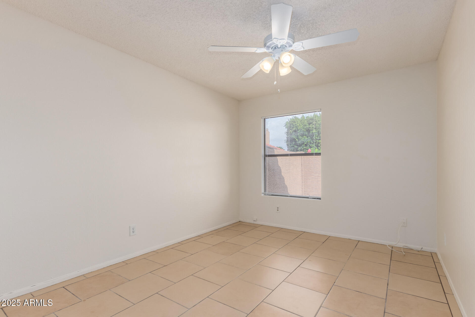 4346 East Sandia Street, Unit 5815 Phoenix, AZ 85044 - Photo 17 of 20 an empty room with windows and fan
