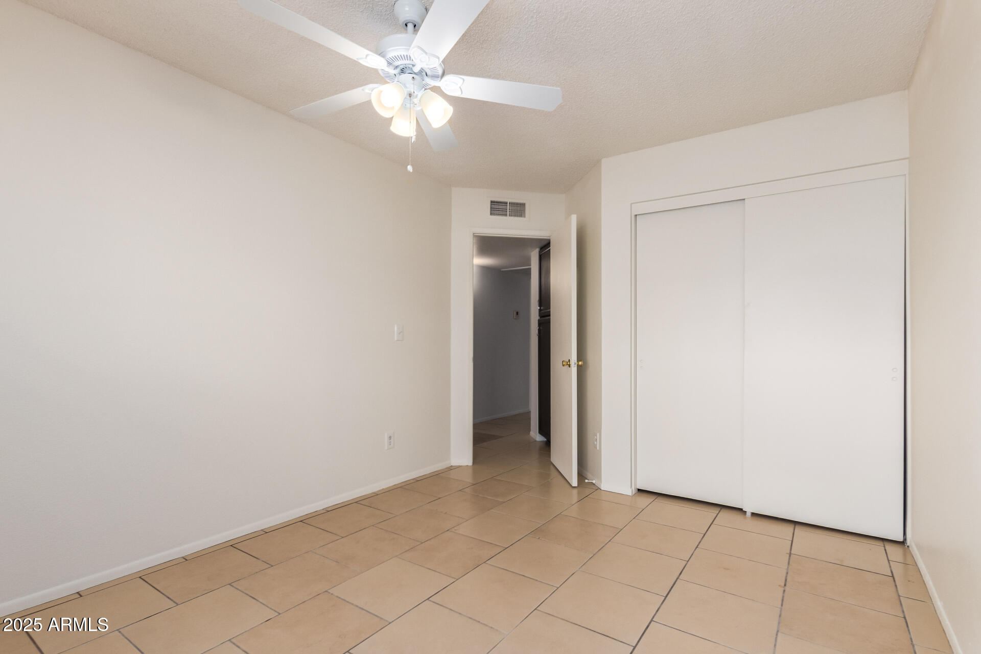 4346 East Sandia Street, Unit 5815 Phoenix, AZ 85044 - Photo 18 of 20 an empty room and chandelier fan