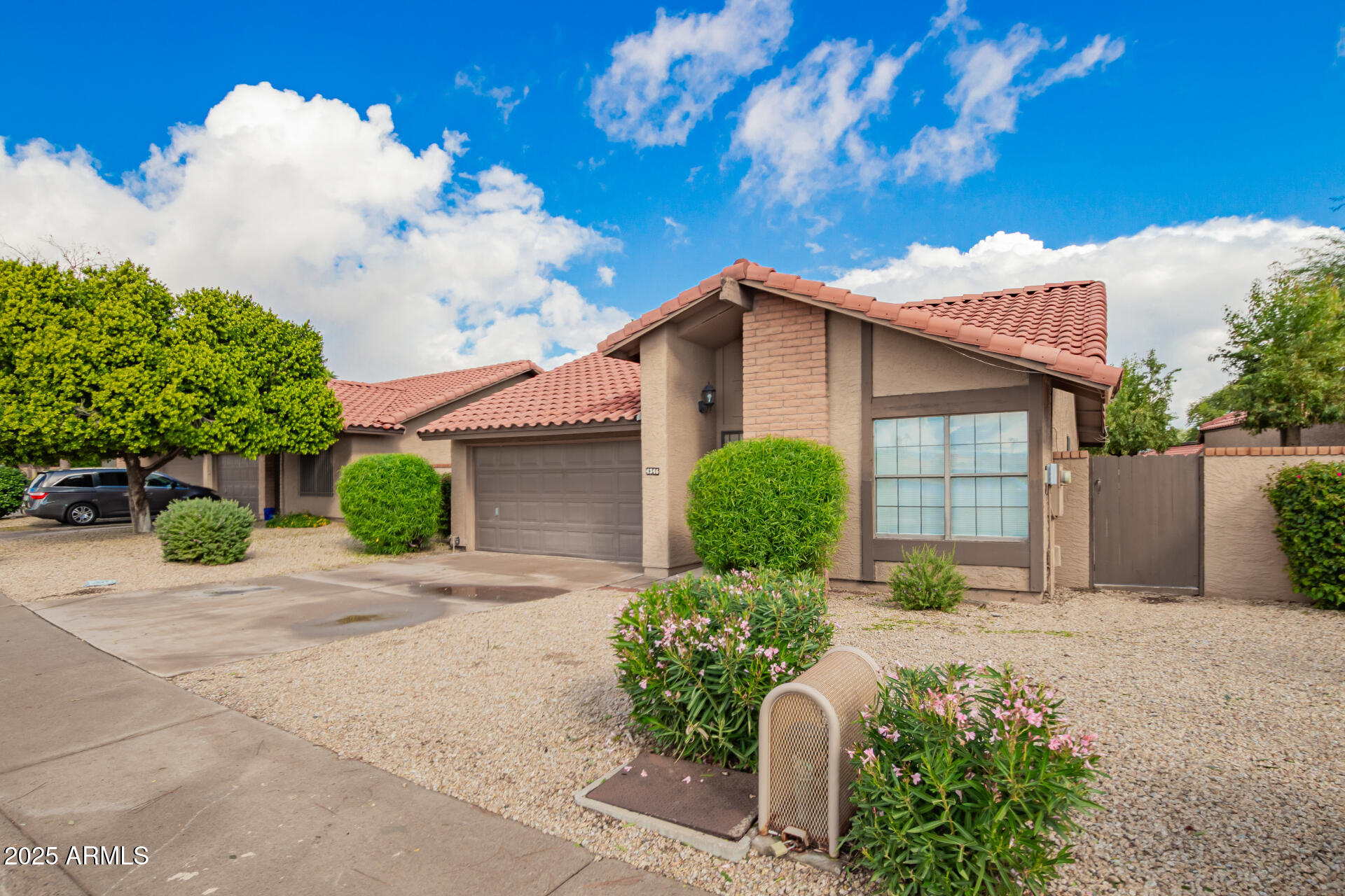 4346 East Sandia Street, Unit 5815 Phoenix, AZ 85044 - Photo 2 of 20 a front view of a house with garden