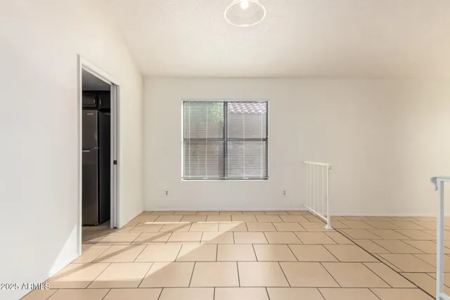 a kitchen with kitchen island white cabinets a refrigerator and a stove