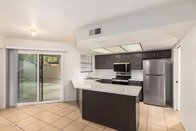 a kitchen with stainless steel appliances a sink stove and microwave