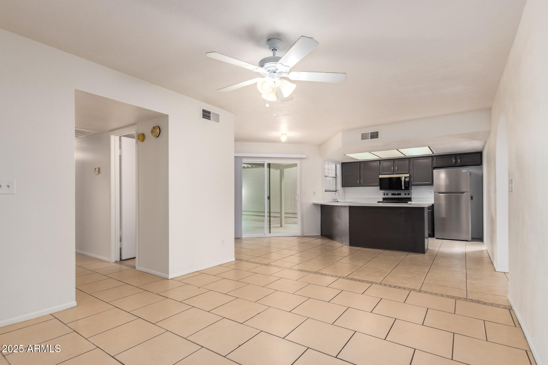 4346 East Sandia Street, Unit 5815 Phoenix, AZ 85044 - Photo 9 of 20 a large white kitchen with a sink and dishwasher a refrigerator with white cabinets