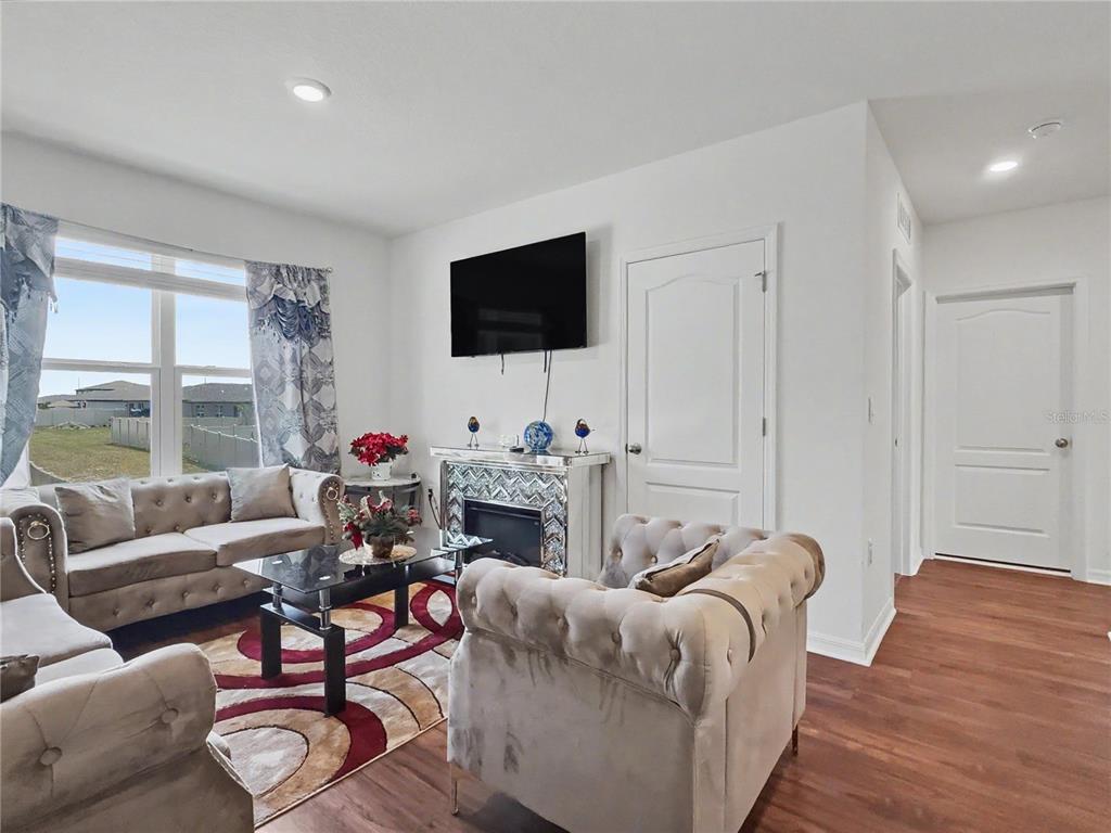 2085 Doe Run Drive Davenport, FL 33837 - Photo 24 of 44 a living room with furniture a flat screen tv and a large window