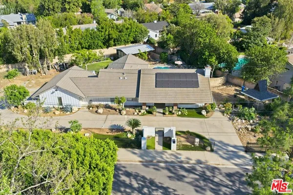 an aerial view of a house with a yard and lake view
