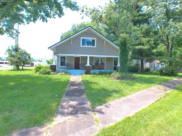 a front view of house with yard and green space