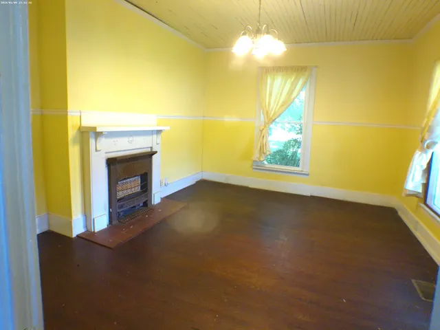 a view of empty room with a fireplace and fan